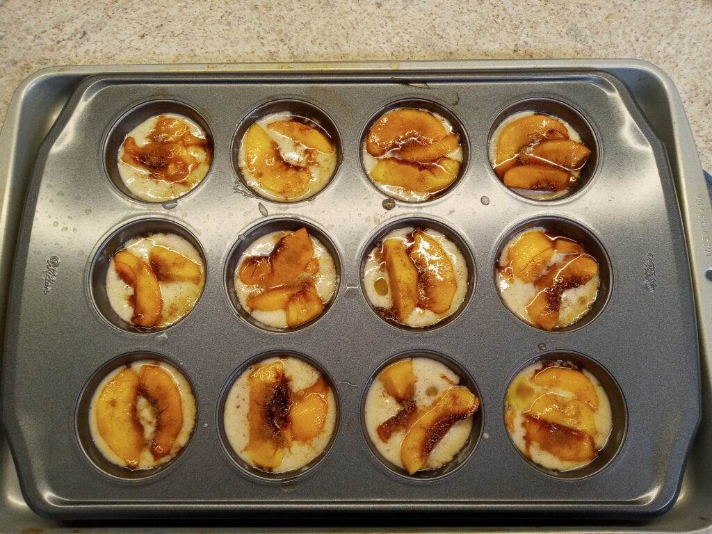 Easy peach cobbler ready for cooking in muffin pan