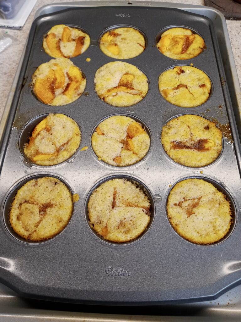 Freshly baked southern peach cobbler in muffin pan