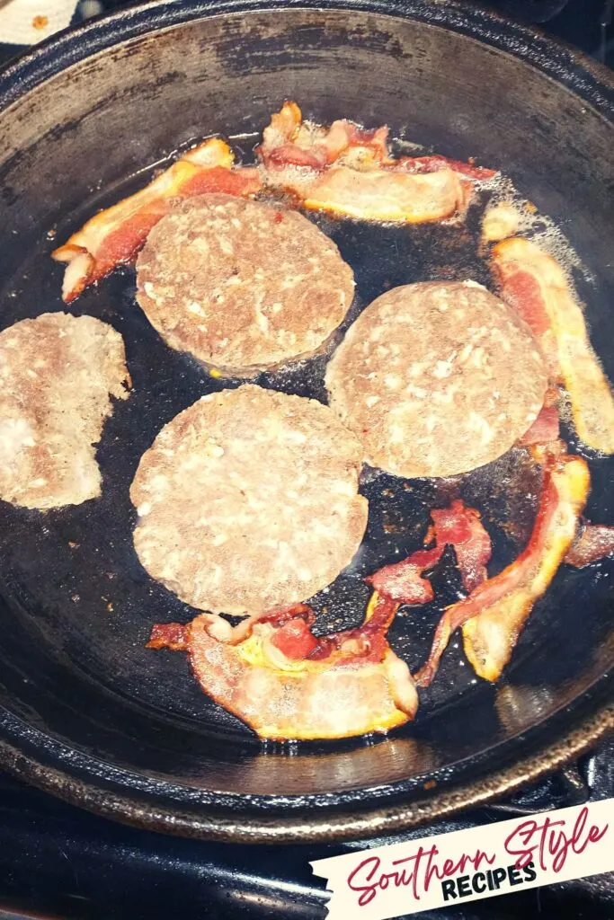 sausage and bacon frying in cast iron skillet