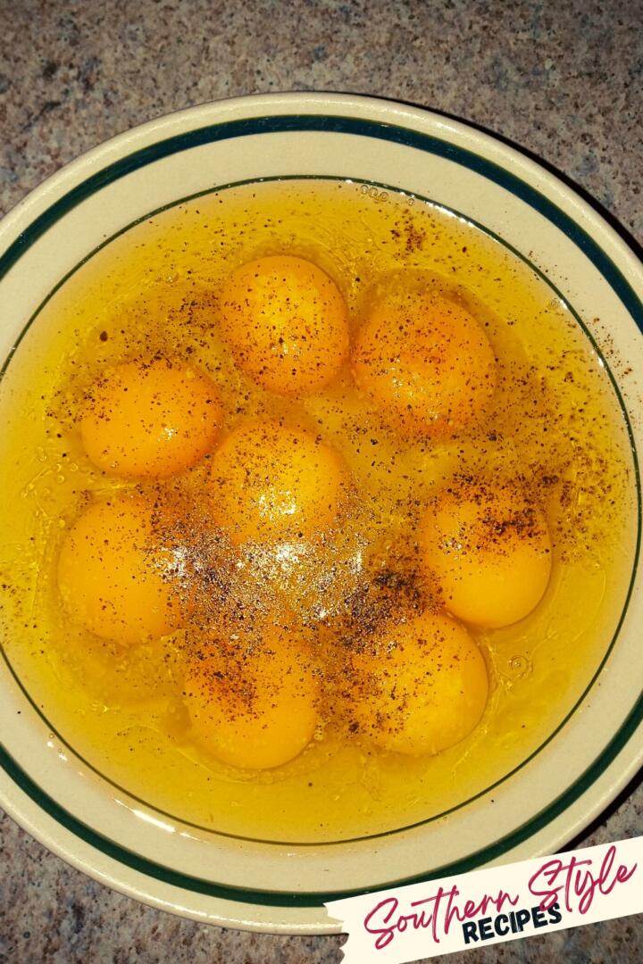 eight cracked eggs with salt and pepper waiting to be scrambled