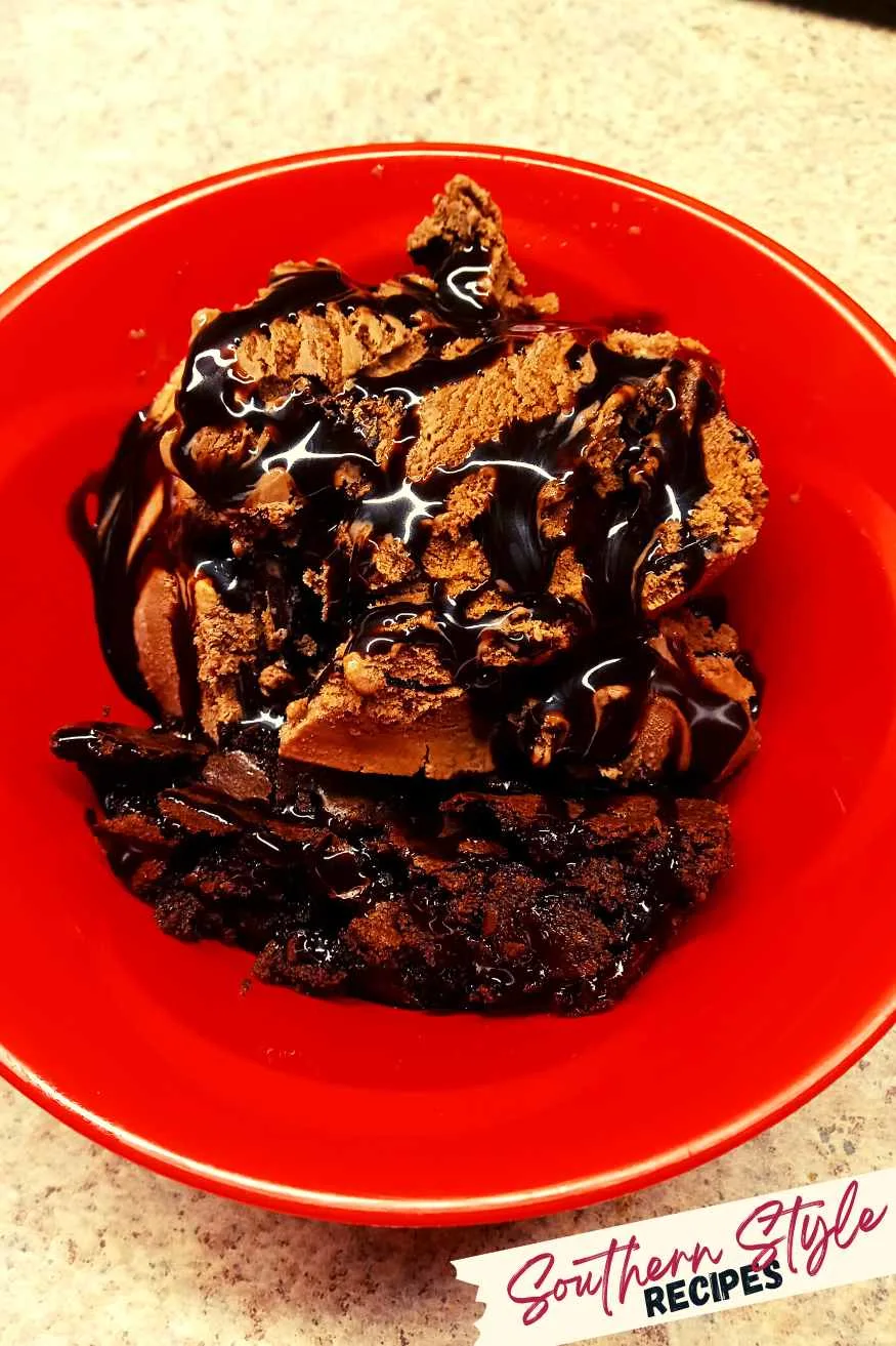Homemade brownie with chocolate ice cream and drizzled with chocolate syrup